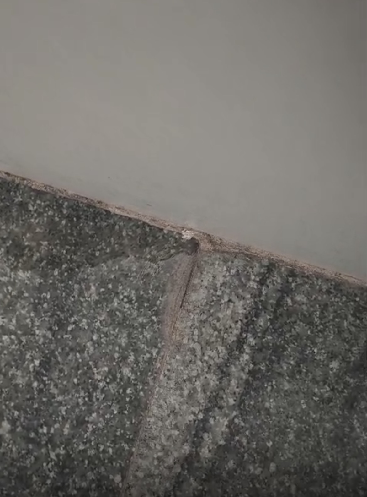 Corroded bathroom floor drain outlet causing active leak in Vijayanagar
